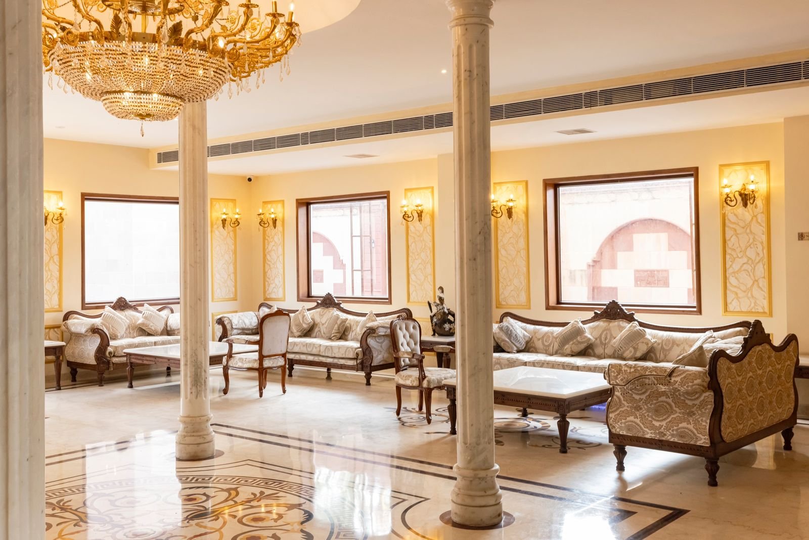 Elegant hotel lobby with chandelier and lounge seating